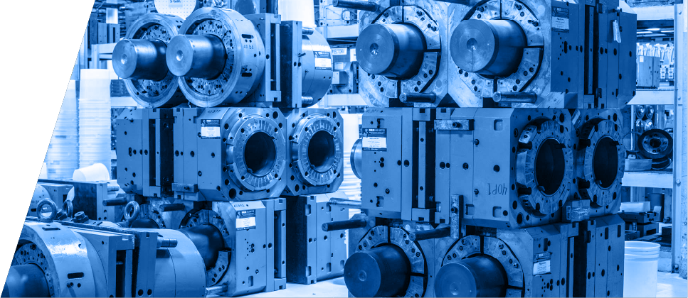Industrial injection molds stacked in a warehouse
